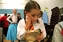 A girl applies make-up for her part in a play
