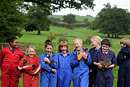 Children on a farm laughing and holding ducks