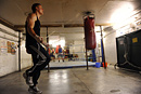 A boxing skips with a rope during a training session