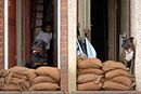 Residents stack sandbags in doorways to stop flooding, two dogs keep watch for any water
